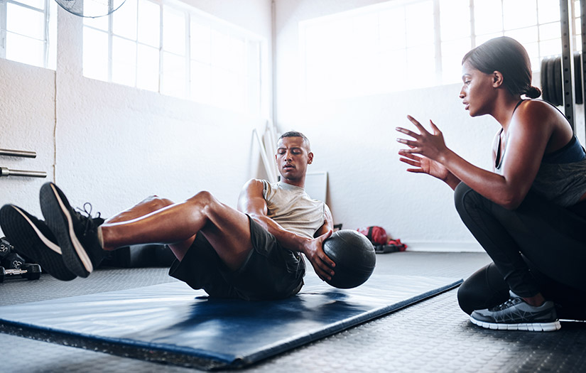 trainer helping client do cardio resistance training